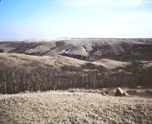 View of Monolith 1 and general site area on a tributary of the Eagle Creek valley, 1988.; Government of Saskatchewan, Frank Korvemaker, 1988.