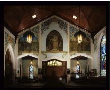 General view of St. Jude's Anglican Church, showing a series of painted murals around the nave presenting events in the life of Jesus Christ.; Parks Canada Agency/ Agence Parcs Canada.