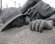 detail of the prone figure of the Belgian War Memorial, Winnipeg, 2006; Historic Resources Branch, Manitoba Culture, Heritage and Tourism, 2006