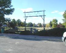 View of the property, including gate sign, cairn and plaque, 2004.; Dan Knutson, 2004.
