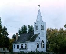 View of front and north elevations, showing central spire and symmetrical Gothic-arched windows, 1987.; Government of Saskatchewan, Frank Korvemaker, 1987.