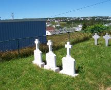 Headstones of Priests, all identical markers; each with a personal message about the deceased.  Photo taken August 2005.; HFNL/ Deborah O'Rielly 2006.