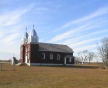 View of cairn, church and cemetery from south-east corner of lot, 2005.; Government of Saskatchewan, Michael Thome, 2005.