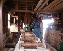 Interior photo of the Wakeham Sawmill, Placentia, NL, showing part of the saw mechanism, taken during Doors Open Placentia event, 2004.; HFNL 2005