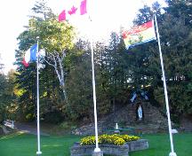 The Grotto and the Calvary - view of the Grotto and the flags.; Village of Saint-Louis-de-Kent