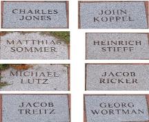 The stone nameplates list names of the first permanent settlers to Moncton.; Moncton Museum