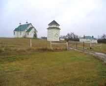 View southeast showing relationship to adjacent church and bell tower, 2005.; Government of Saskatchewan, Marvin Thomas, 2005.