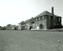 This view shows the east elevation of the passenger depot, the former restaurant, and the office building.; Parks Canada Agency / Agence Parcs Canada, Marilyn E. Armstrong-Reynolds, 1990.