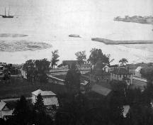 View north showing the Dalhousie Marketplace, now Rotary Memorial Park, at center right, appearing as a fenced enclosure behind the Courthouse and Jail.  ; Restigouche Regional Museum, Dalhousie