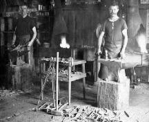 G. Robbie Moir and William Tarves at work in Moir's blacksmith shop circa 1909.; Township of Langley, Serial No.459