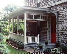 View of the porch and main entrance on the east elevation of the building – July 1991; OHT, 1991