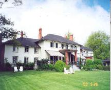 View of the main (east) façade showing the centre house and wings – May 2000; OHT, 2000