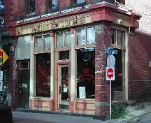 Image showing the storefront and illustrating the cast iron pilasters, end columns, cornice, windows, and entrance; City of Saint John 2004