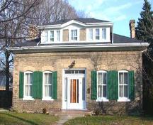 West facing façade featuring the centred dormer, two chimneys, and arch radiating voussiors, 2002.; Department of Planning, City of Brantford, 2002.
