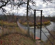 Contextual view, from the east, of the Senkiw School Suspension Bridge, Roseau River area, 2006; Historic Resources Branch, Manitoba Culture, Heritage and Tourism, 2006