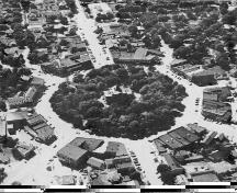 An aerial view of the Square, looking west, most closely aligned with East and West Streets.; Gordon Henderson, July 1950