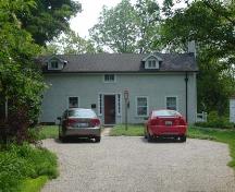 Of note are the gable roof, small windows and box-like appearance of the house.; Kayla Jonas, 2007.