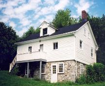 Bethune –Thompson Workers' Cottage, south Elevation showing kitchen entrance at grade, July 2004; OHT, 2006