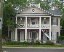 Of note are the Doric columns, bull's eye window in the attic gable and low balustrade.; Kayla Jonas, 2007.
