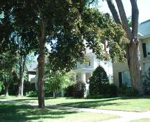 Of note are the large trees that create the district's park-like character.; Kendra Green, 2007.