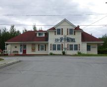 The symmetrical and balanced north facade of the building, visible from the village, includes a small hipped dormer. ; PNB 2005