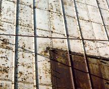 Detail view of Elevator 5 B, showing the large riveted steel plates, 1995.; Parks Canada Agency / Agence Parcs Canada, J. Hallé, 1995.