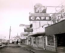 Historic view of Goodmanson Building and Round Up Cafe neon sign, circa 1950; City of Surrey, 2007