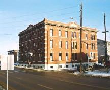 This image shows details of the main facade of the Hecla Block facing west with a  neoclassically-influenced entrance canopy.; City of Edmonton, 2004