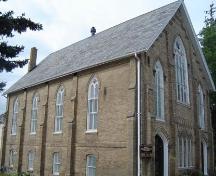 Of note are the double trefoil lancet windows between each brick buttress.; Kayla Jonas, 2007.