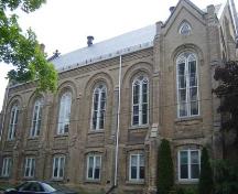 Of note are the round-headed windows and the triangular window in the gable.; Kayla Jonas, 2007.