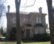 Featured are paired, arched upper windows and one-storey entry porch supported by circular columns.; Lindsay Benjamin, 2007.