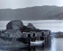 Historic photo showing fisheries premises around The Quidnock, Conche, NL, circa 1970s.; Courtesy C. Cochrane, 2008