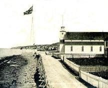 Historic image of the original John Guy flagstaff. The present day flag and pole are located on the same site. Photo taken circa 1910.; Town of Cupids 2008