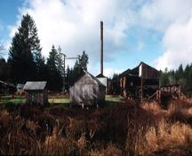 View of McLean Mill National Historic Site of Canada, showing the utilitarian design and materials of structures at the site, 1996.; Parks Canada Agency / Agence Parcs Canada, 1996.