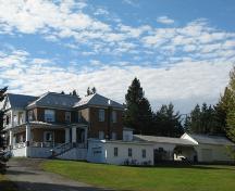 Angled view, the presbytery is visible as well as an old carriage house; Madawaska Planning Commission