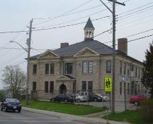 Featured is the symmetrical stone façade with hipped roof and bracketed wooden cornice.; Kayla Jonas, 2007.
