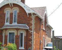 Of note is the bay window with mansard style roof.; Beatrice Tam, 2008.