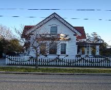 Of note is the sharply-pitched gable roof, with  intricate bargeboard.; Kayla Jonas, 2008.