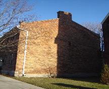 Featured is one of the parapet gable ends, defined by a chimney.; Kayla Jonas, 2008.