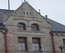 Featured is the massive pediment on the façade, topped by finials.; Kayla Jonas, 2007.