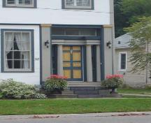 Featured is the front entrance with Doric columns, sidelights and transom.; Kayla Jonas, 2007.