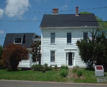South side elevation with main portion of the building and the attached barn to the left with the Person of National Historic Interest monument in the foreground.; Province of New Brunswick, Heritage Branch