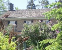 Featured is the gable roof and one of the brick chimneys.; Chelsey Tyers, 2008.