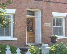 Featured is the centrally located, deeply recessed front entrance flanked by two windows.; Kirsten Pries, 2008.