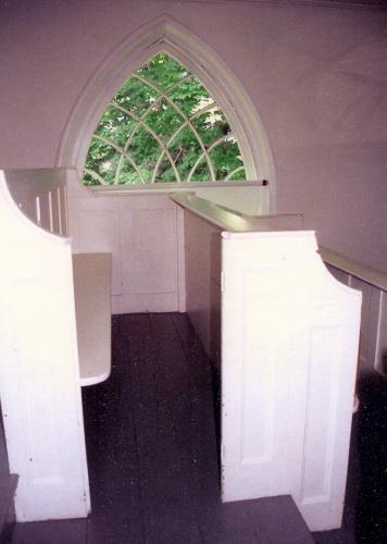 Showing balcony pews and Gothic window
