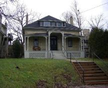Of note is the hip roof and full veranda.; Emily Elliot, 2008.