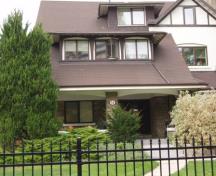 Featured is the large partial width porch with square stone columns.; Paul Dubniak, 2009.