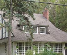 Featured is the gently slopping roof line and large, three-bayed dormer window.; Paul Dubniak, 2009.