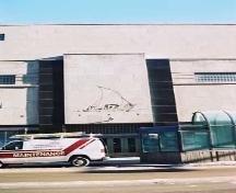 This view of the Hudson's Bay Company Department Store illustrates one of the west entrances on 103 Street with a decorative frieze above the entrance doors flanked by black granite panels.; City of Edmonton, 2004