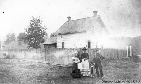 John Walter and family in front of their house